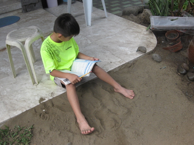 James studying on front stoop